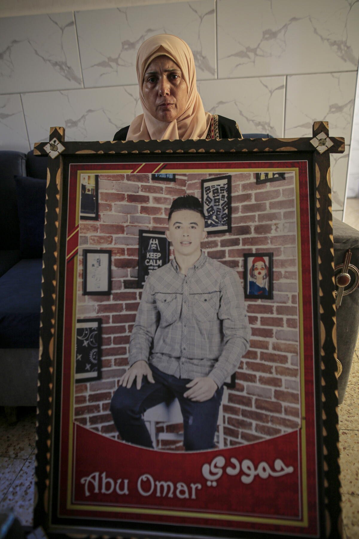 Aida Al-Drimli con una foto de su hijo Mahmoud Al-Drimli. 